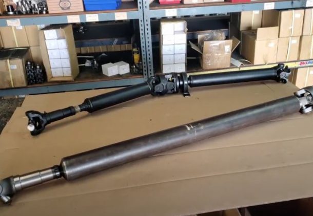 A gladiator 2 piece driveshaft next to a gladiator 1 piece drive shaft