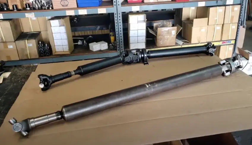 A gladiator 2 piece driveshaft next to a gladiator 1 piece drive shaft