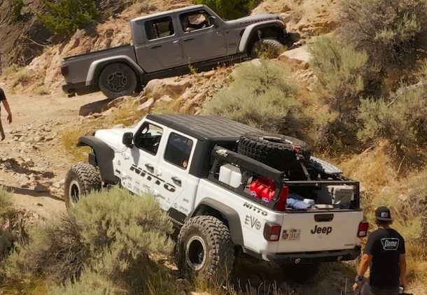 2 jeep gladiators rock climbing on a hill