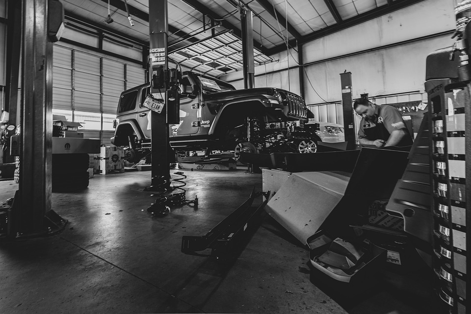 a lifted jeep in a shop getting ready to be worked on